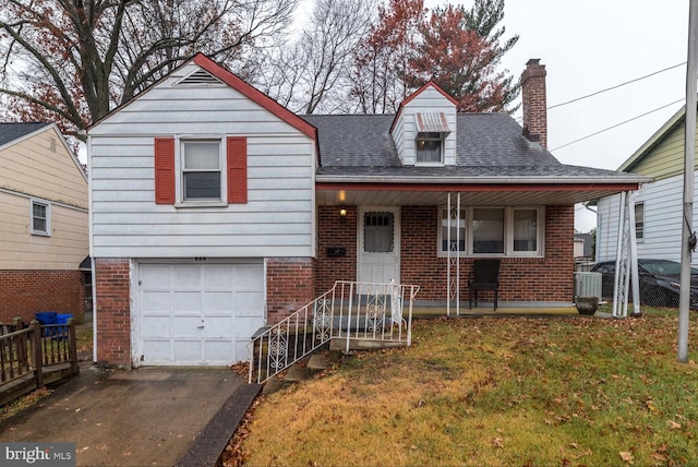 view of front of home with a porch, a garage, and a front lawn