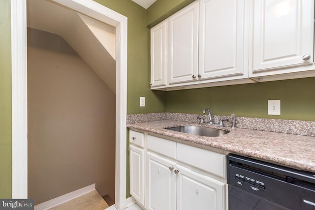 kitchen featuring white cabinets, light tile patterned flooring, sink, and black dishwasher