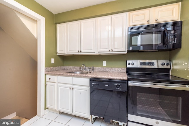 kitchen featuring white cabinetry, sink, light tile patterned floors, and black appliances