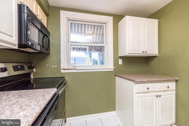 kitchen with light tile patterned floors, white cabinets, and stainless steel range with electric stovetop