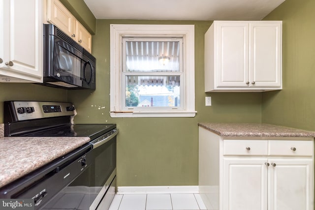 kitchen with white cabinetry, light tile patterned floors, and stainless steel electric range