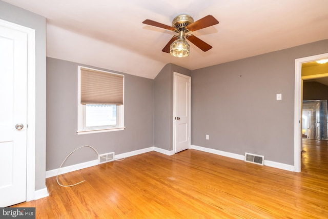 empty room featuring ceiling fan and hardwood / wood-style floors