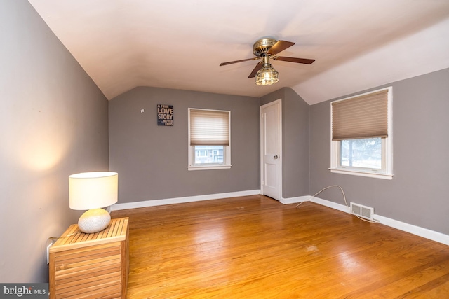 bonus room with ceiling fan, a healthy amount of sunlight, wood-type flooring, and vaulted ceiling