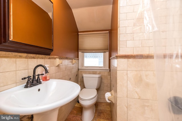 bathroom featuring sink, tile patterned flooring, tile walls, and toilet