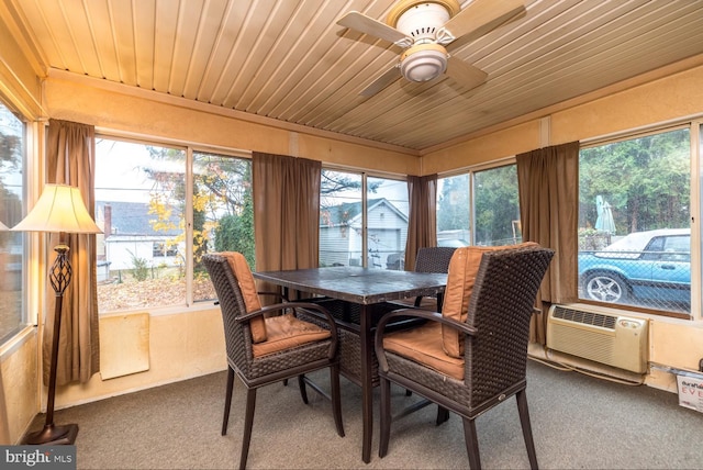 sunroom with ceiling fan, a healthy amount of sunlight, and wooden ceiling