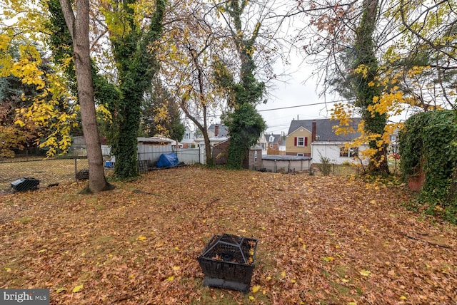 view of yard with a fire pit