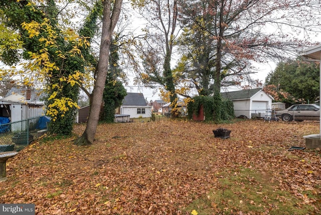 view of yard featuring an outbuilding and a garage