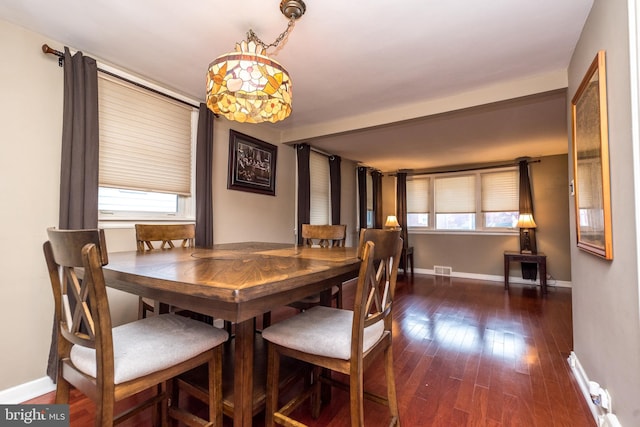 dining space featuring plenty of natural light and dark hardwood / wood-style flooring