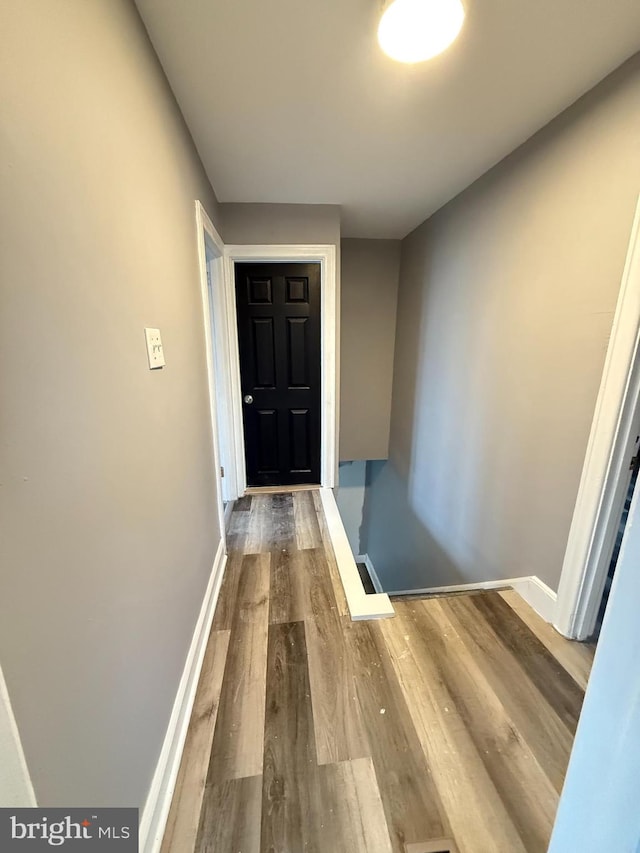 corridor with wood-type flooring