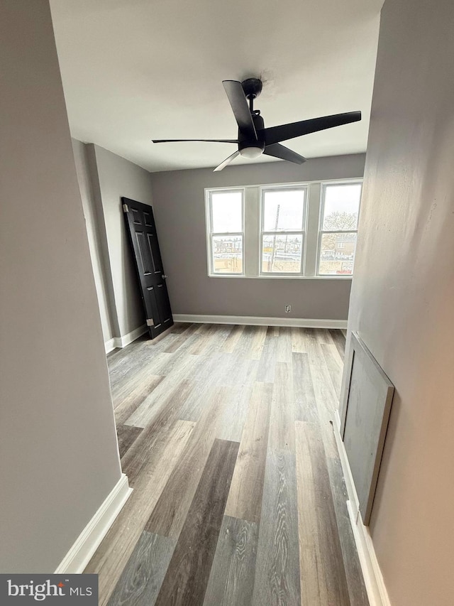 spare room featuring light hardwood / wood-style floors and ceiling fan