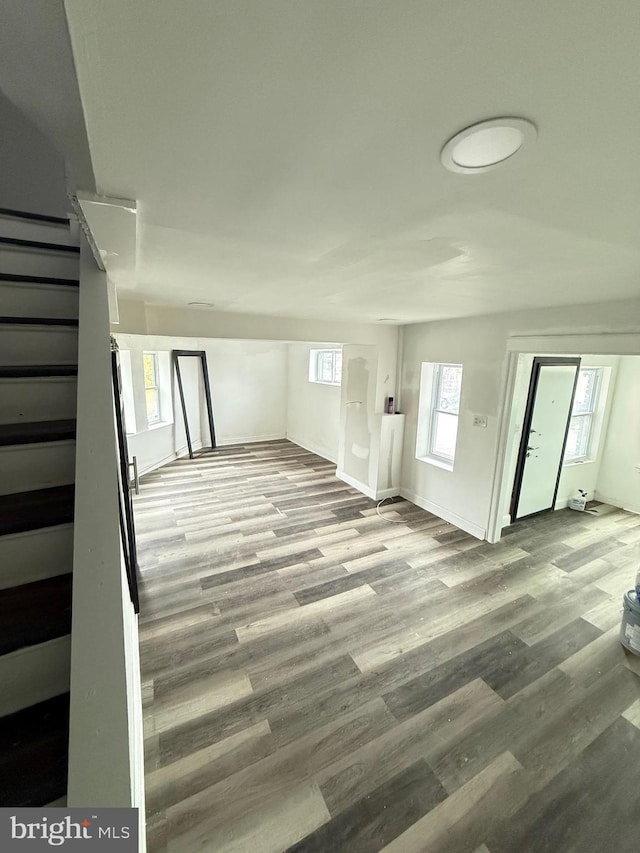 unfurnished living room with plenty of natural light and light hardwood / wood-style floors