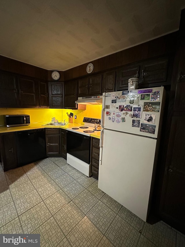 kitchen featuring dark brown cabinetry, white appliances, and sink