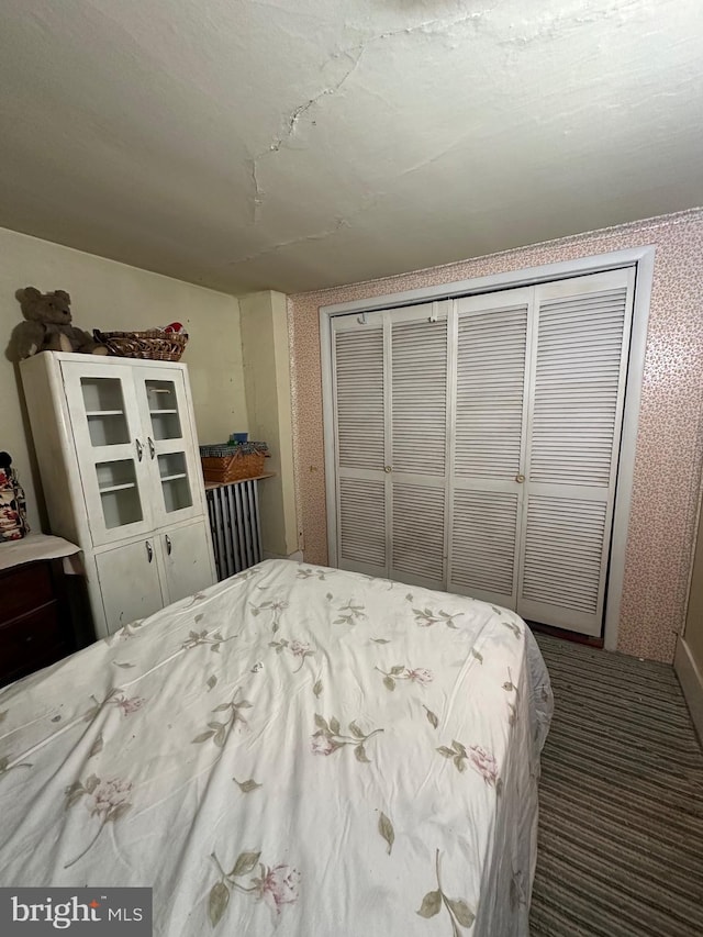 carpeted bedroom with a closet