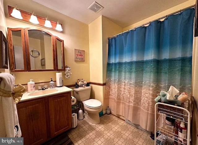 bathroom featuring vanity, curtained shower, and toilet