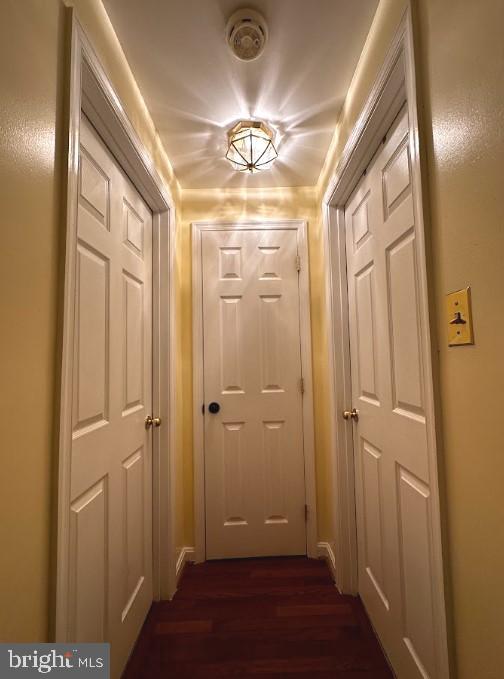 corridor featuring dark hardwood / wood-style flooring