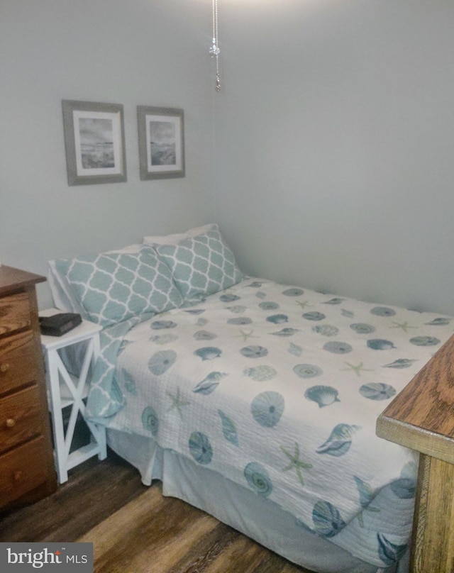 bedroom with dark hardwood / wood-style flooring