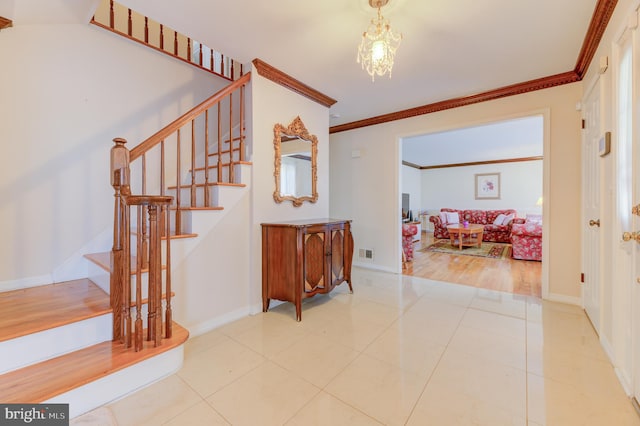 stairway with wood-type flooring, crown molding, and a chandelier