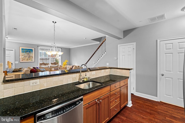 kitchen featuring dishwasher, dark stone counters, sink, hanging light fixtures, and dark hardwood / wood-style floors