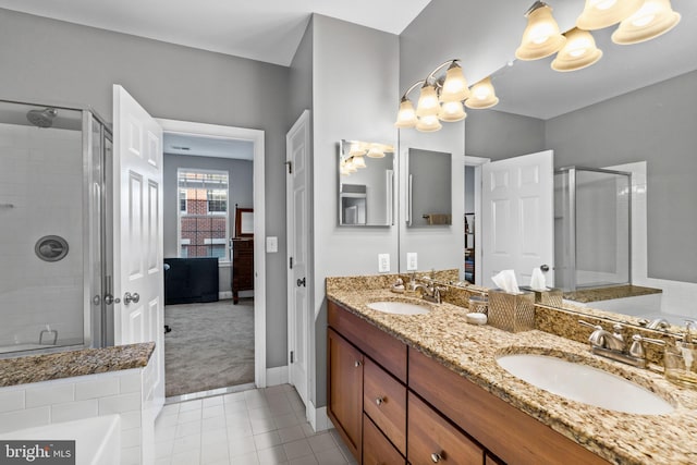 bathroom featuring tile patterned flooring, vanity, and shower with separate bathtub