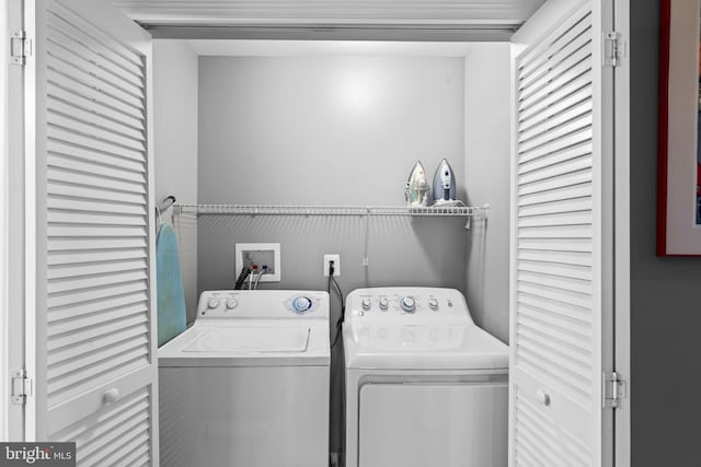 clothes washing area featuring washing machine and clothes dryer