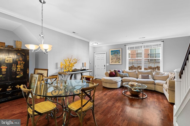 dining area featuring dark hardwood / wood-style floors, crown molding, and a notable chandelier