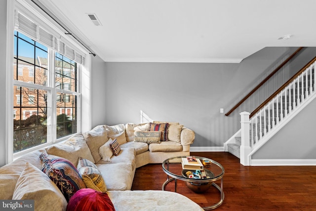 living room featuring hardwood / wood-style flooring and crown molding