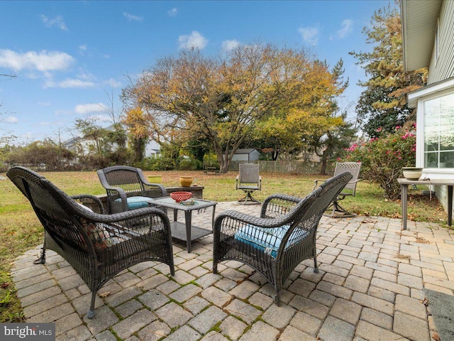 view of patio featuring an outdoor living space with a fire pit