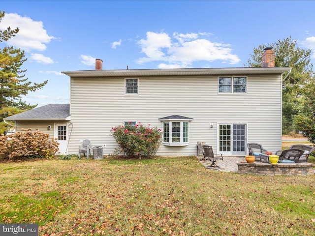 rear view of property with a yard, a patio area, and central air condition unit