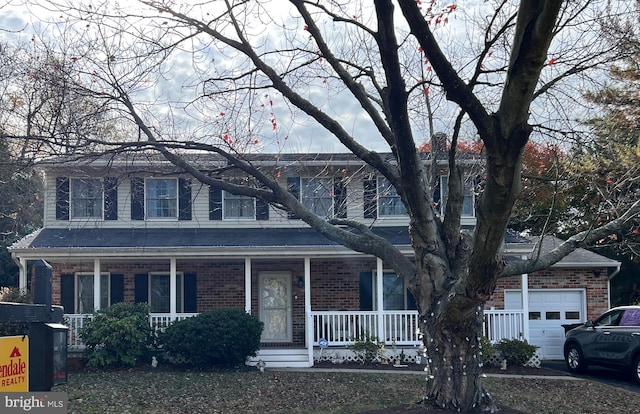 view of front of house with a porch and a garage