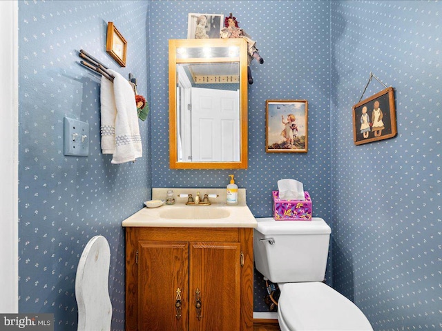 bathroom featuring vanity and toilet