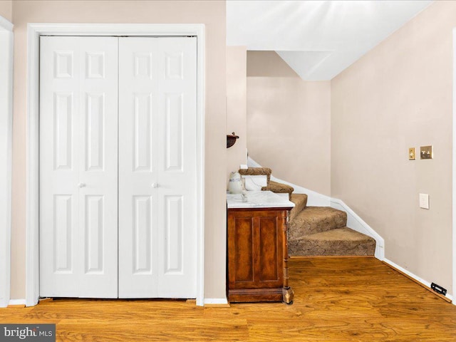 staircase with hardwood / wood-style floors