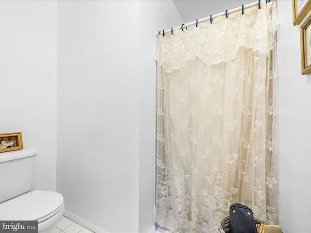 bathroom with toilet and tile patterned floors