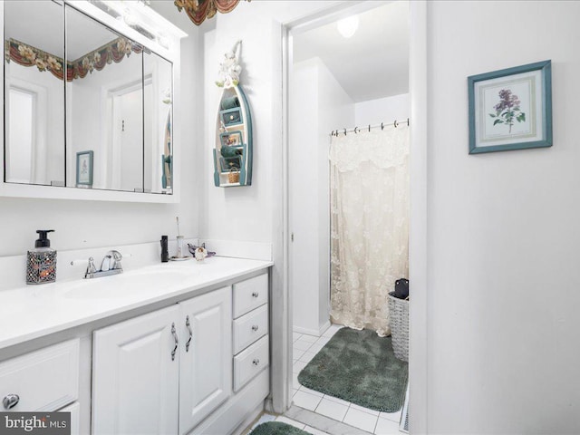 bathroom with tile patterned flooring, vanity, and a shower with curtain