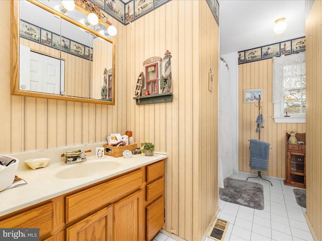 bathroom with tile patterned floors, vanity, and a shower with shower curtain