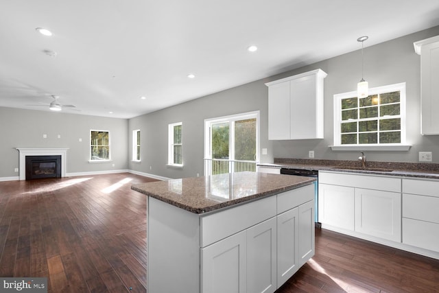 kitchen featuring white cabinets, ceiling fan, dark wood-type flooring, and sink