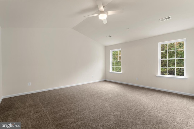 carpeted empty room featuring ceiling fan and vaulted ceiling