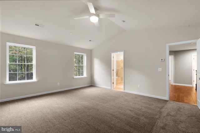 carpeted empty room with ceiling fan and lofted ceiling