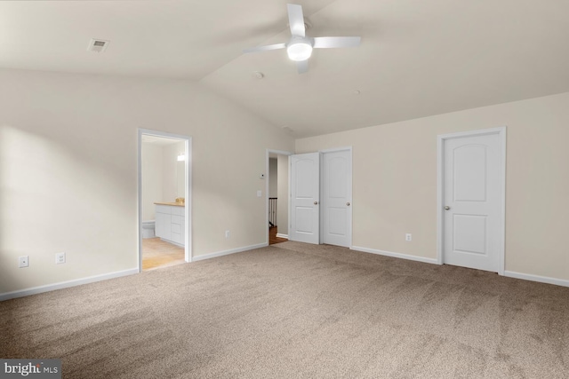 unfurnished bedroom featuring ensuite bathroom, ceiling fan, lofted ceiling, and light carpet