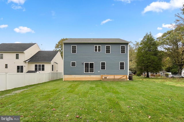 rear view of house with a yard