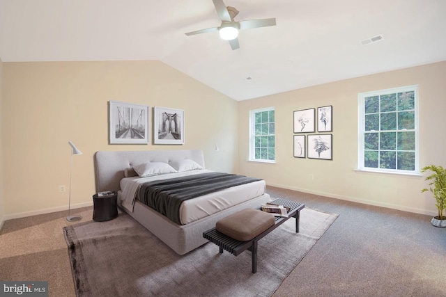 bedroom featuring multiple windows, ceiling fan, carpet floors, and lofted ceiling