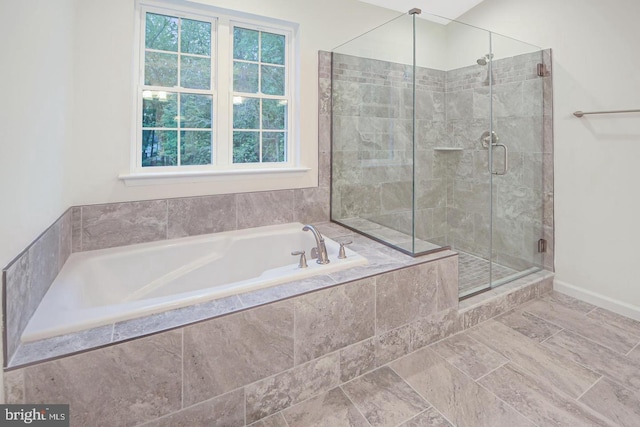 bathroom with shower with separate bathtub