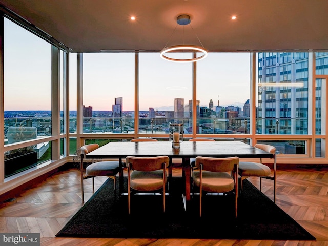 dining space featuring floor to ceiling windows and parquet floors