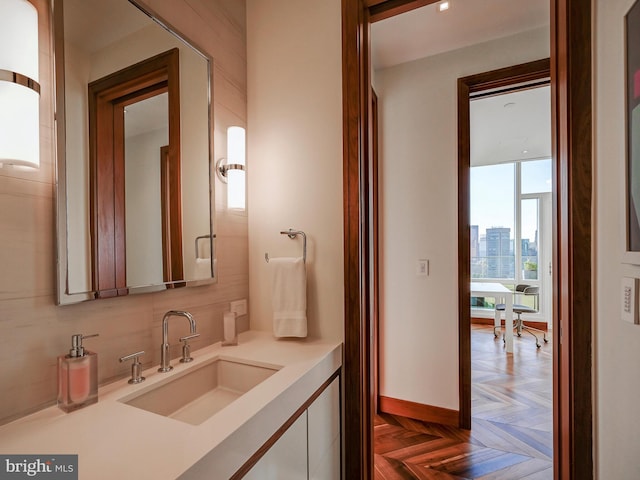 bathroom featuring parquet flooring and vanity