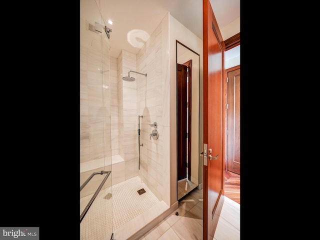 bathroom featuring tile patterned floors and a shower with door