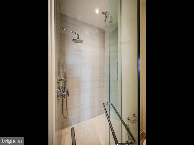 bathroom featuring a shower with door