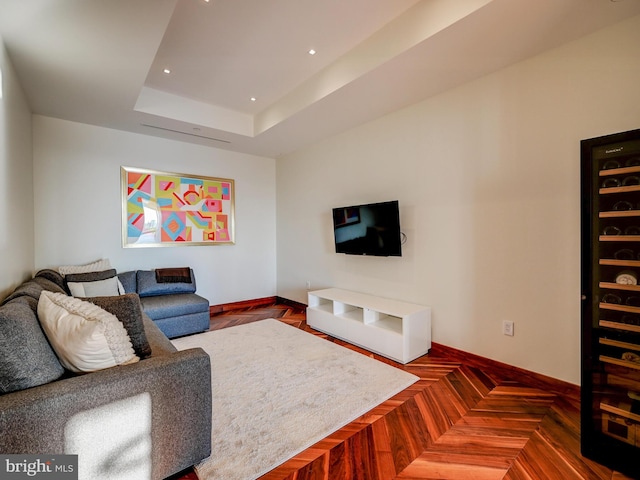 living room with a raised ceiling and parquet floors