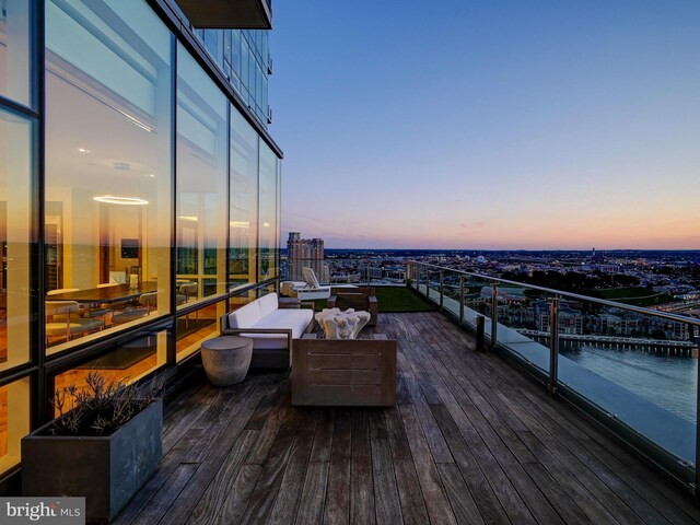 deck at dusk with an outdoor living space