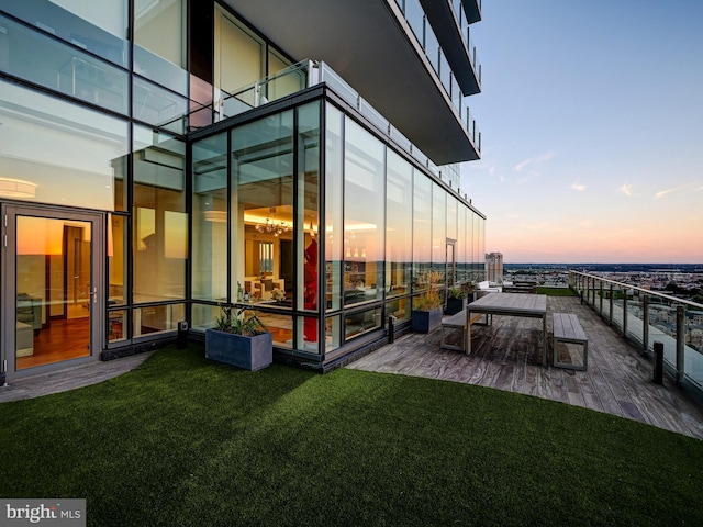 exterior space featuring a patio area, a balcony, and a yard