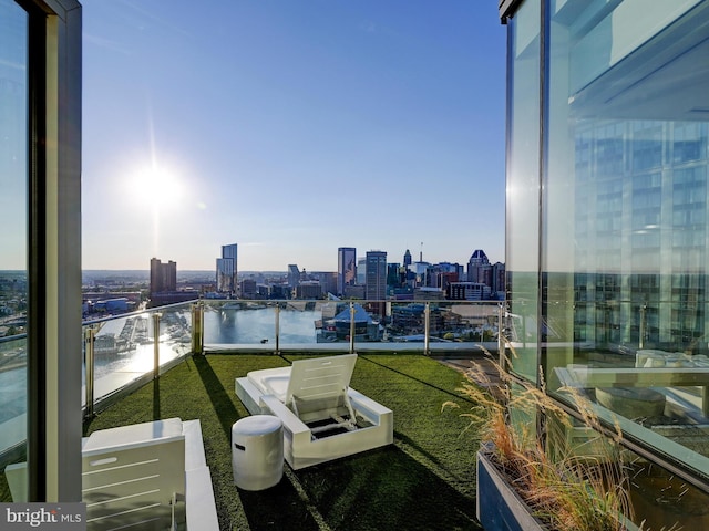 exterior space with a yard, a balcony, and a water view