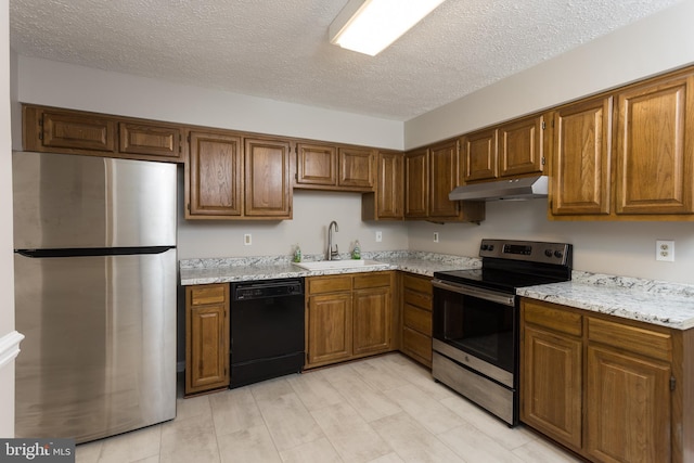 kitchen featuring a textured ceiling, sink, and appliances with stainless steel finishes